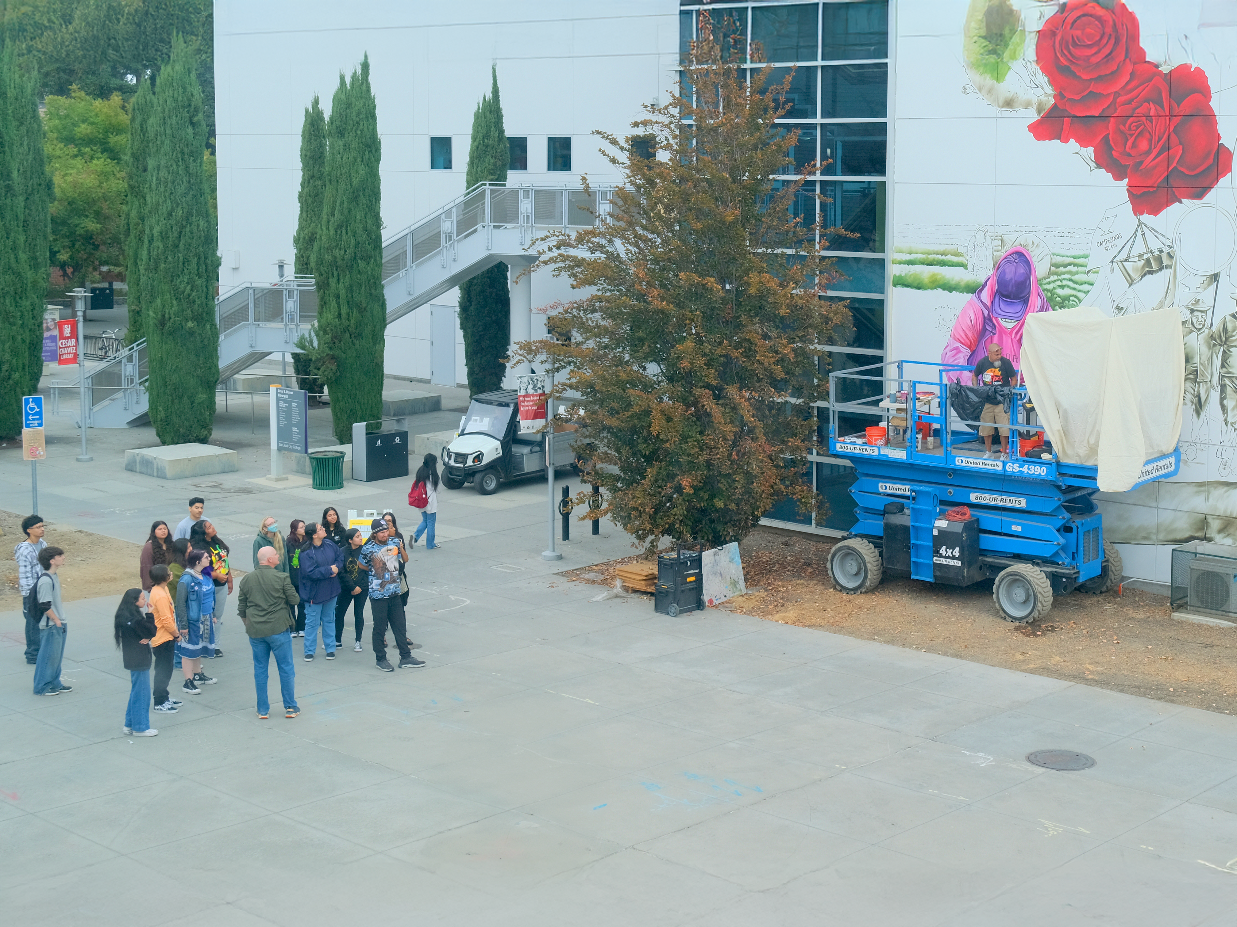 Student tour admiring the work.